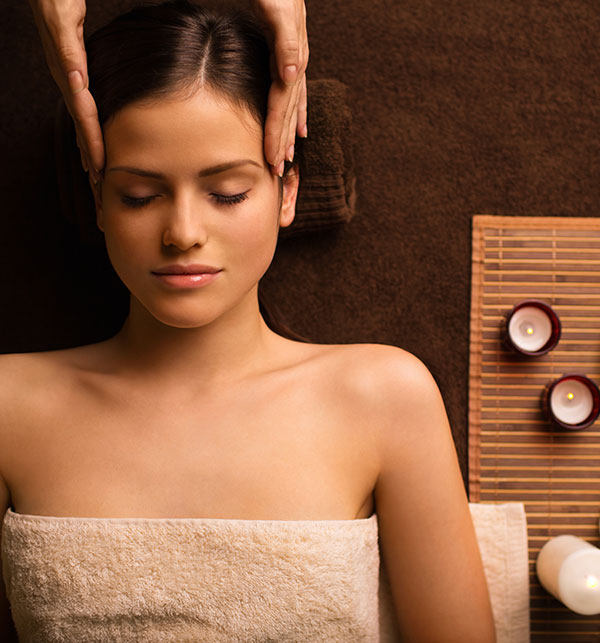 Woman receiving a massage to her temples. 